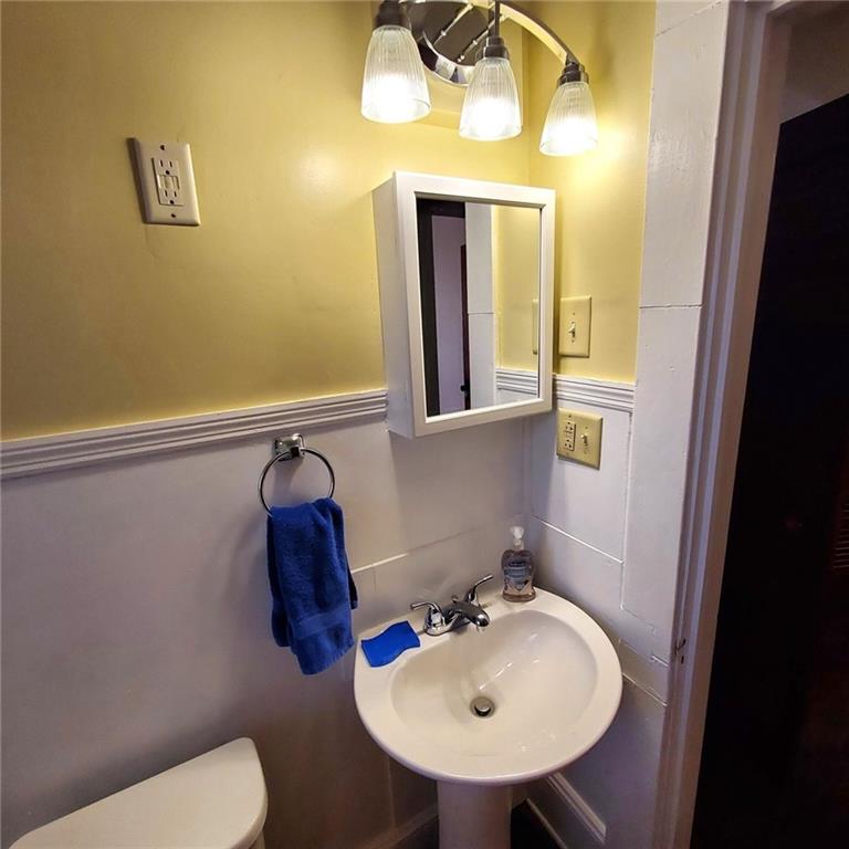 7025 Rico Road Chattahoochee Hills, GA 30268 - Photo 41 of 51 a bathroom with a toilet sink and mirror