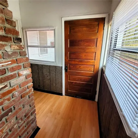a view of kitchen with refrigerator and window