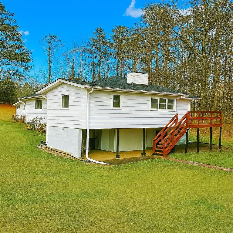7025 Rico Road Chattahoochee Hills, GA 30268 - Photo 47 of 51 a view of a house with a yard and deck