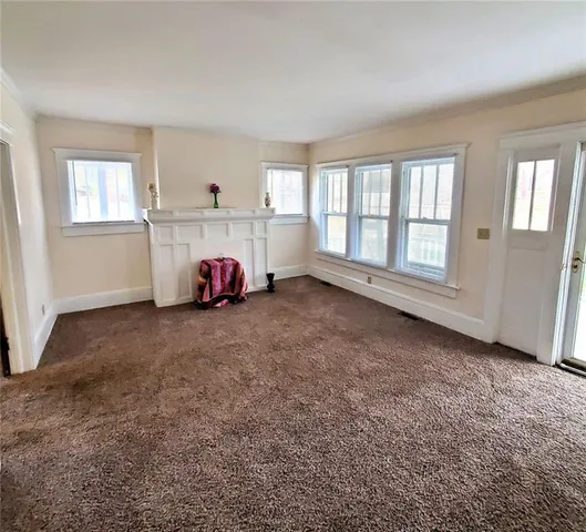 a view of a livingroom with furniture and a window