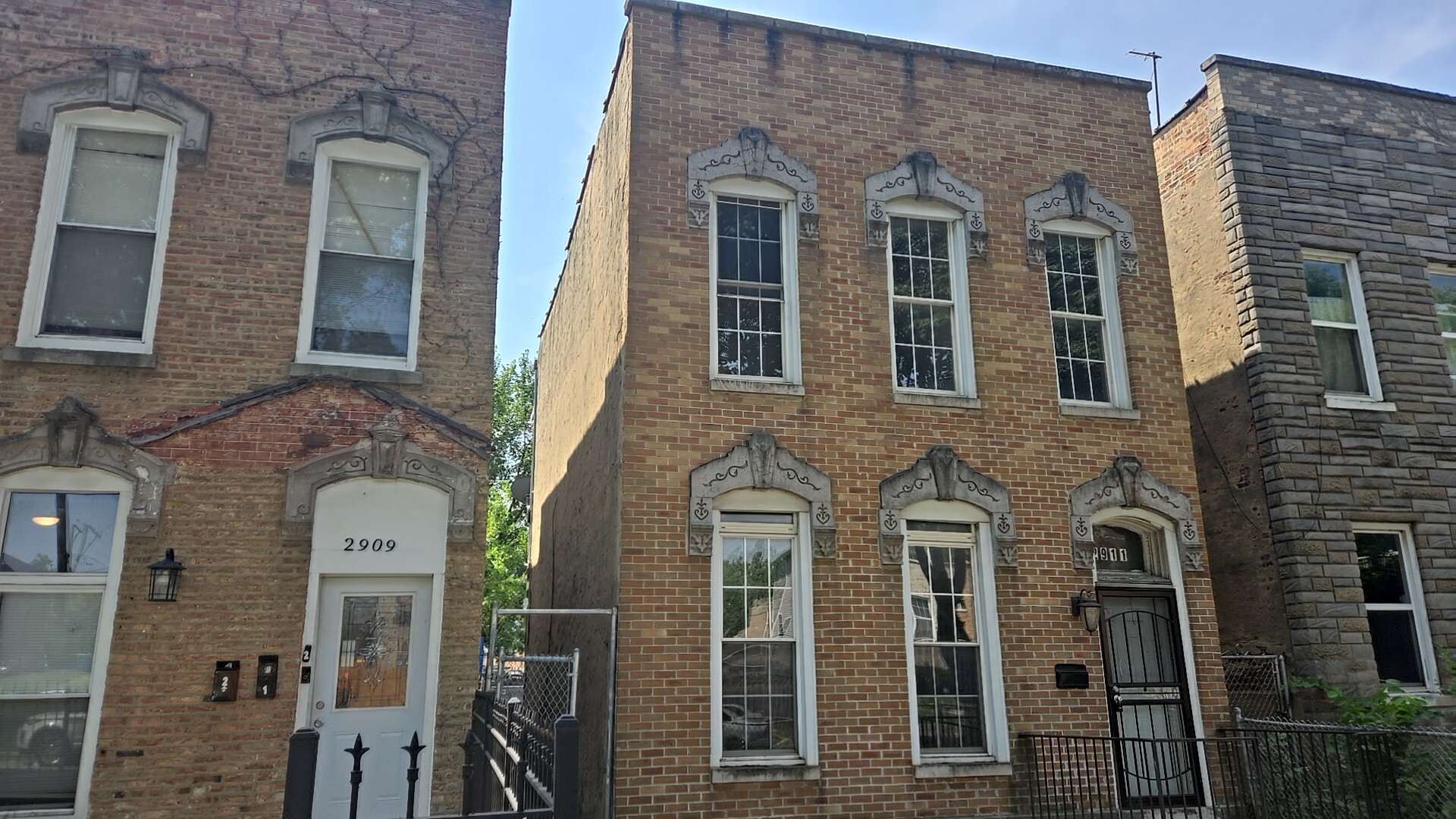 2911 West Walnut Street Chicago, IL 60612 - Photo 3 of 21 front view of a brick house with a large door