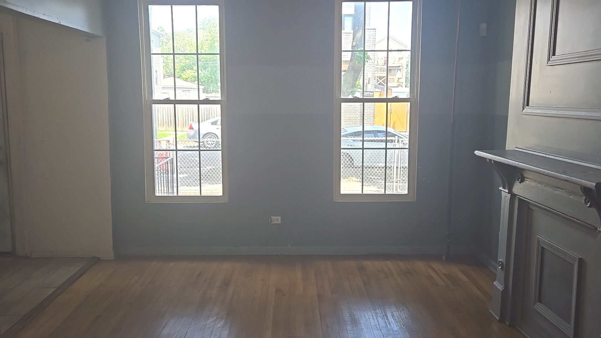 2911 West Walnut Street Chicago, IL 60612 - Photo 6 of 21 a view of an empty room with wooden floor and a window