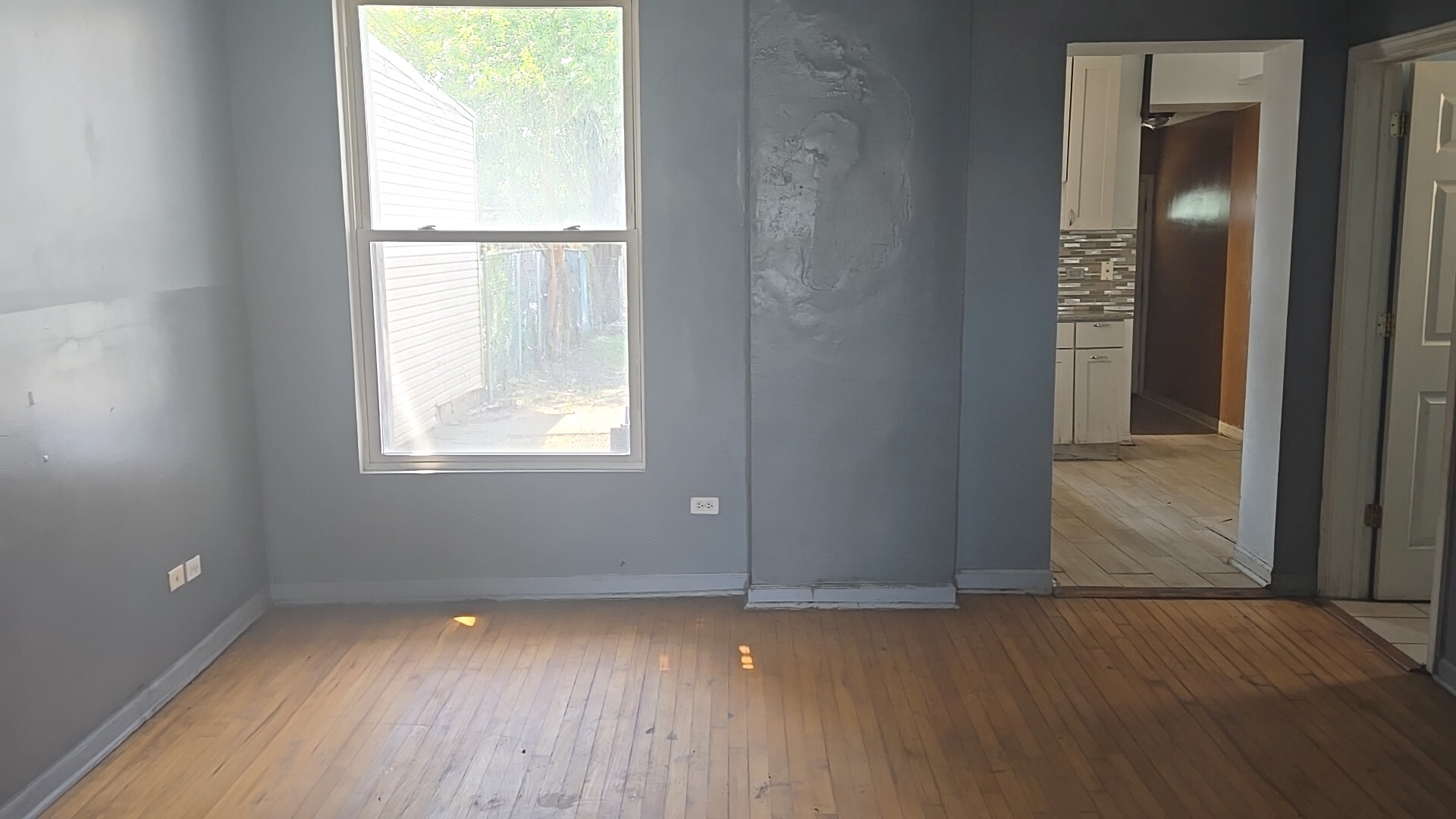 2911 West Walnut Street Chicago, IL 60612 - Photo 7 of 21 an empty room with wooden floor and windows