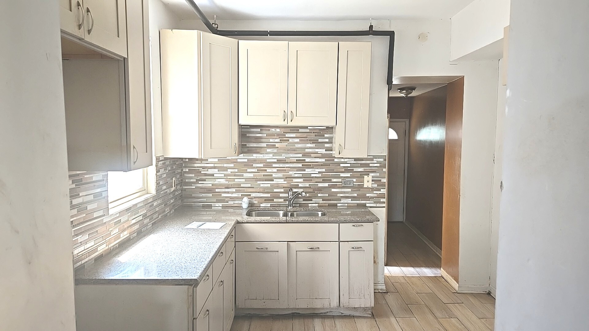 2911 West Walnut Street Chicago, IL 60612 - Photo 9 of 21 a bathroom with a granite countertop sink a vanity and a mirror