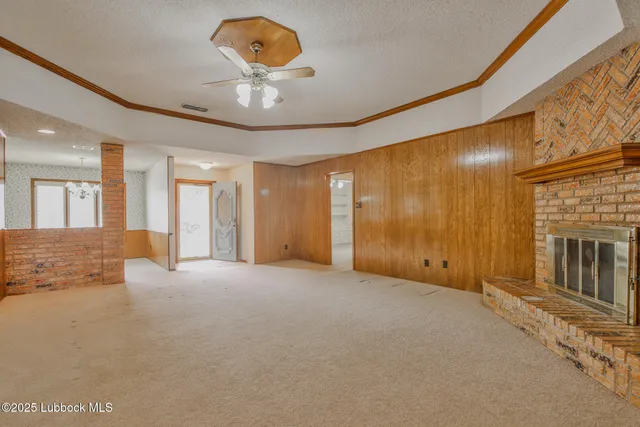 a view of an empty room with a fireplace