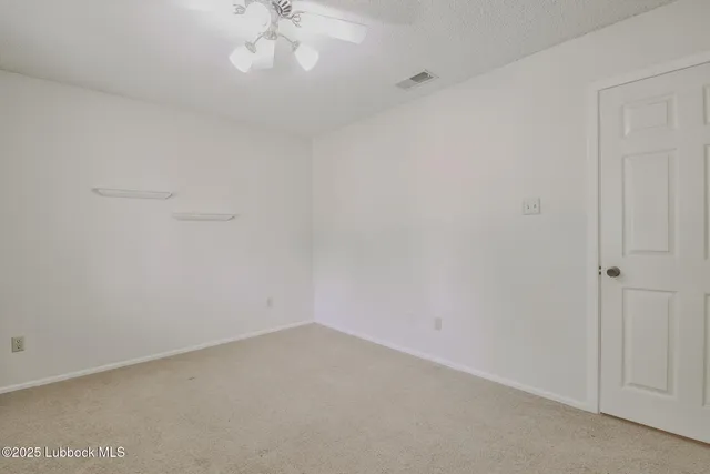 a large white kitchen with cabinets