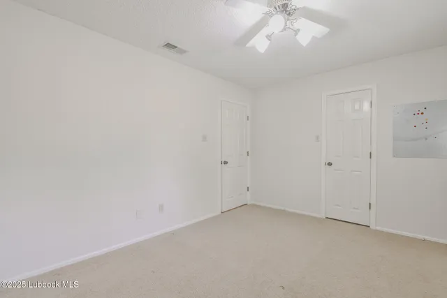 a bathroom with a granite countertop sink mirror vanity and toilet