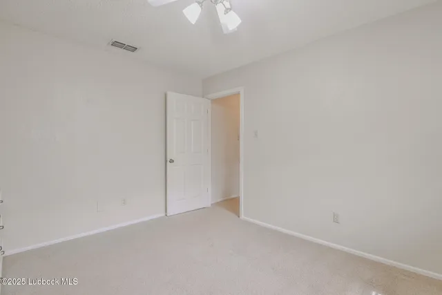 a room that has a fan and a window