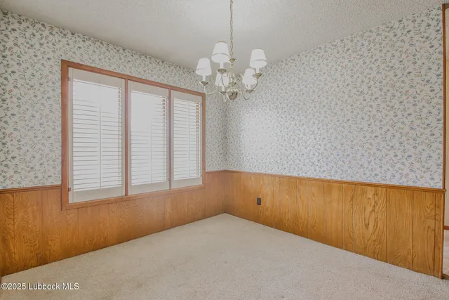a view of a room with a window and a ceiling fan