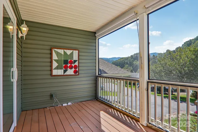 a view of a two chairs in the balcony