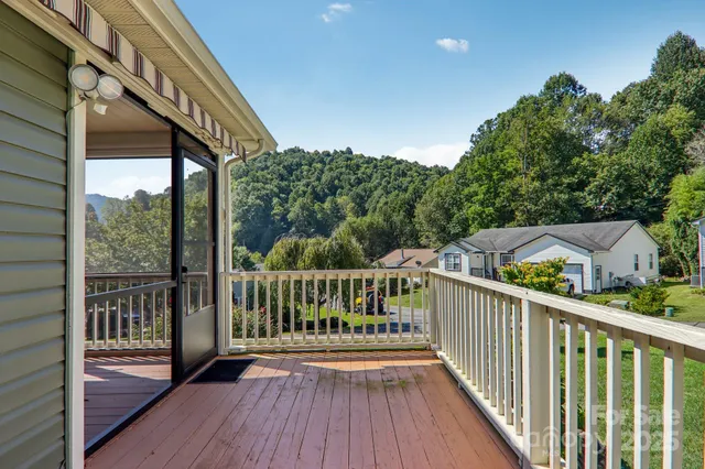 a view of a balcony with wooden floor and fence