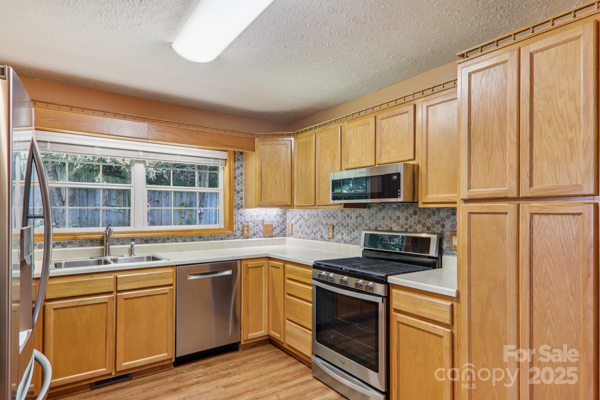 126 Pasco Loop Waynesville, NC 28785 - Photo 13 of 44 a kitchen with stainless steel appliances granite countertop a stove a sink and a microwave