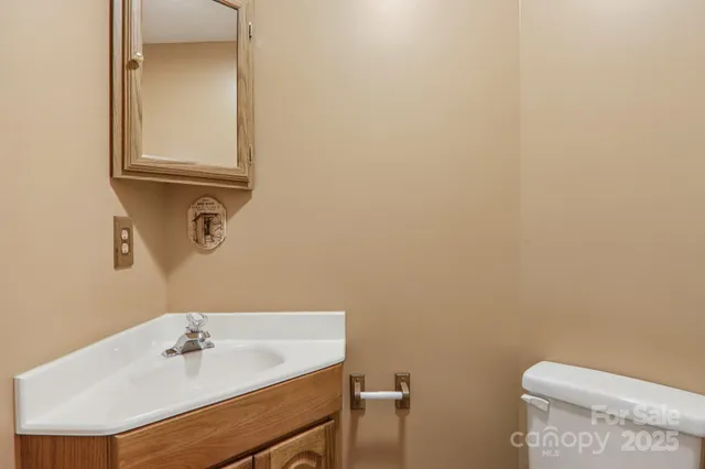 a bathroom with a sink a toilet and mirror