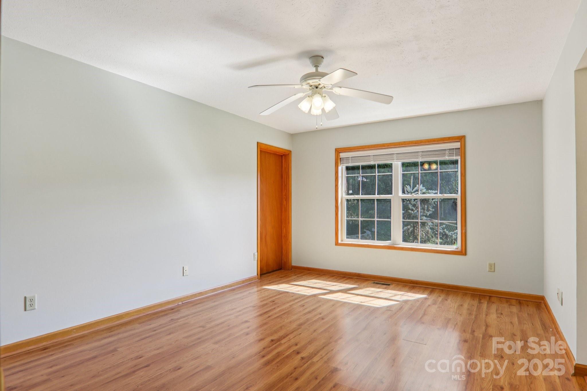 126 Pasco Loop Waynesville, NC 28785 - Photo 19 of 44 a view of an empty room with wooden floor and a window