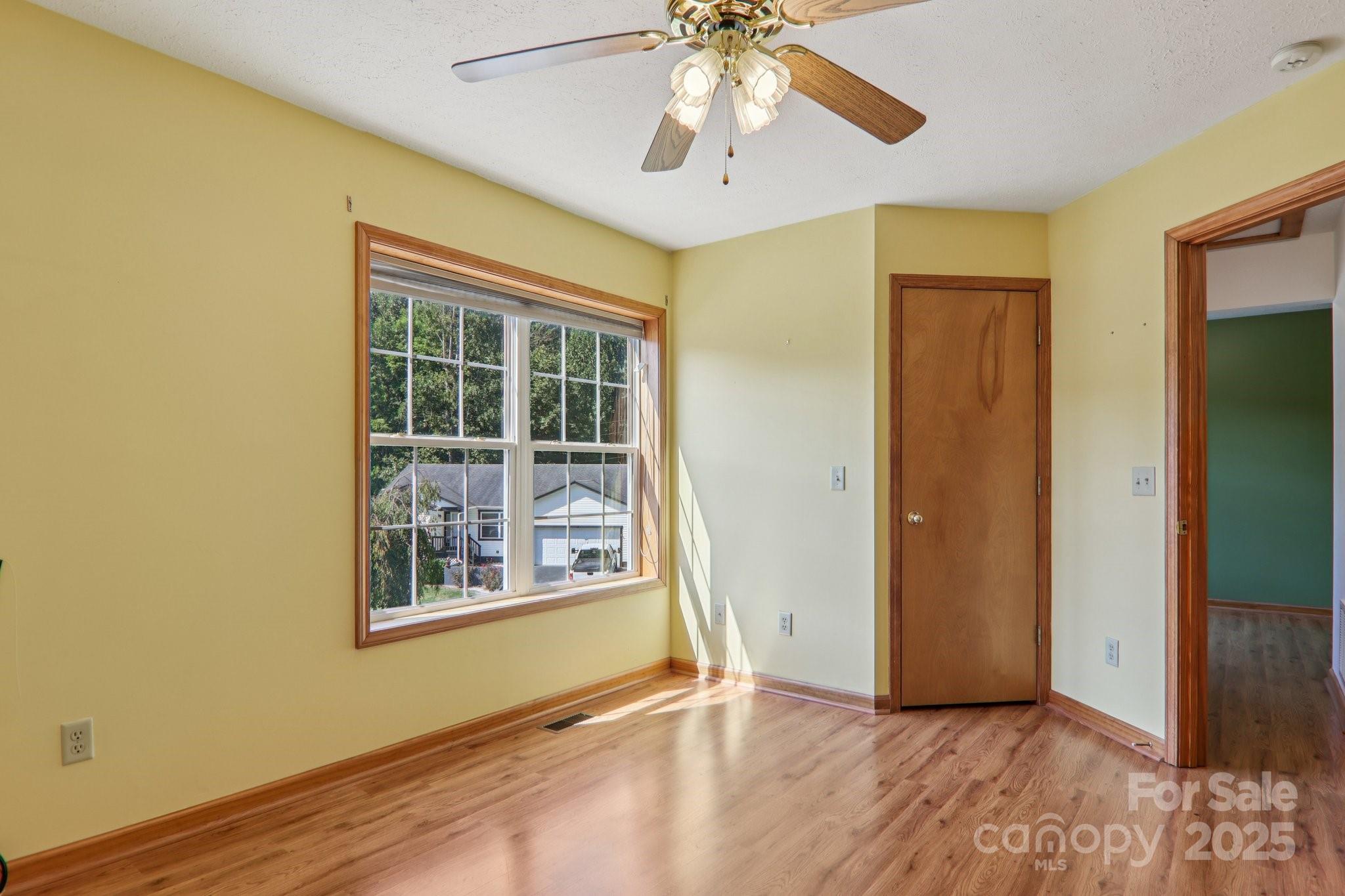 126 Pasco Loop Waynesville, NC 28785 - Photo 26 of 44 a view of an empty room with a window and wooden floor