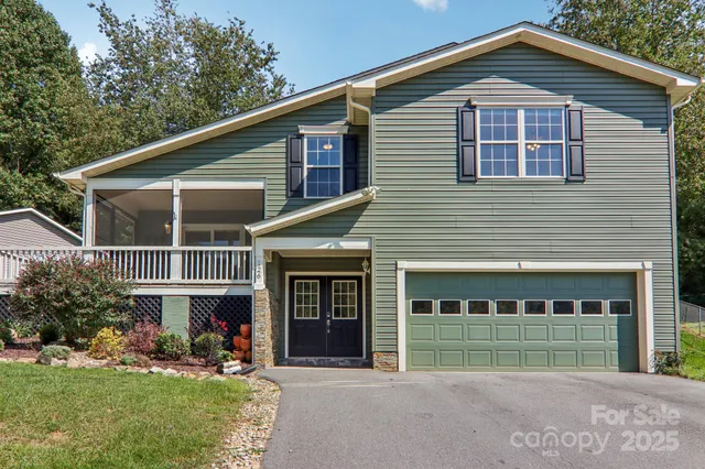 a front view of a house with a yard and porch