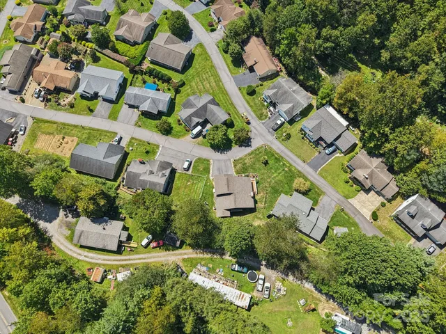 an aerial view of multiple houses with yard