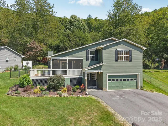 a front view of a house with a yard and porch