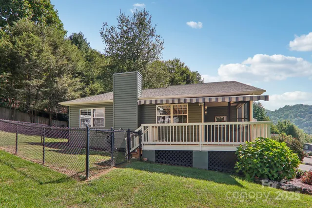 a view of a house with a yard and a garden