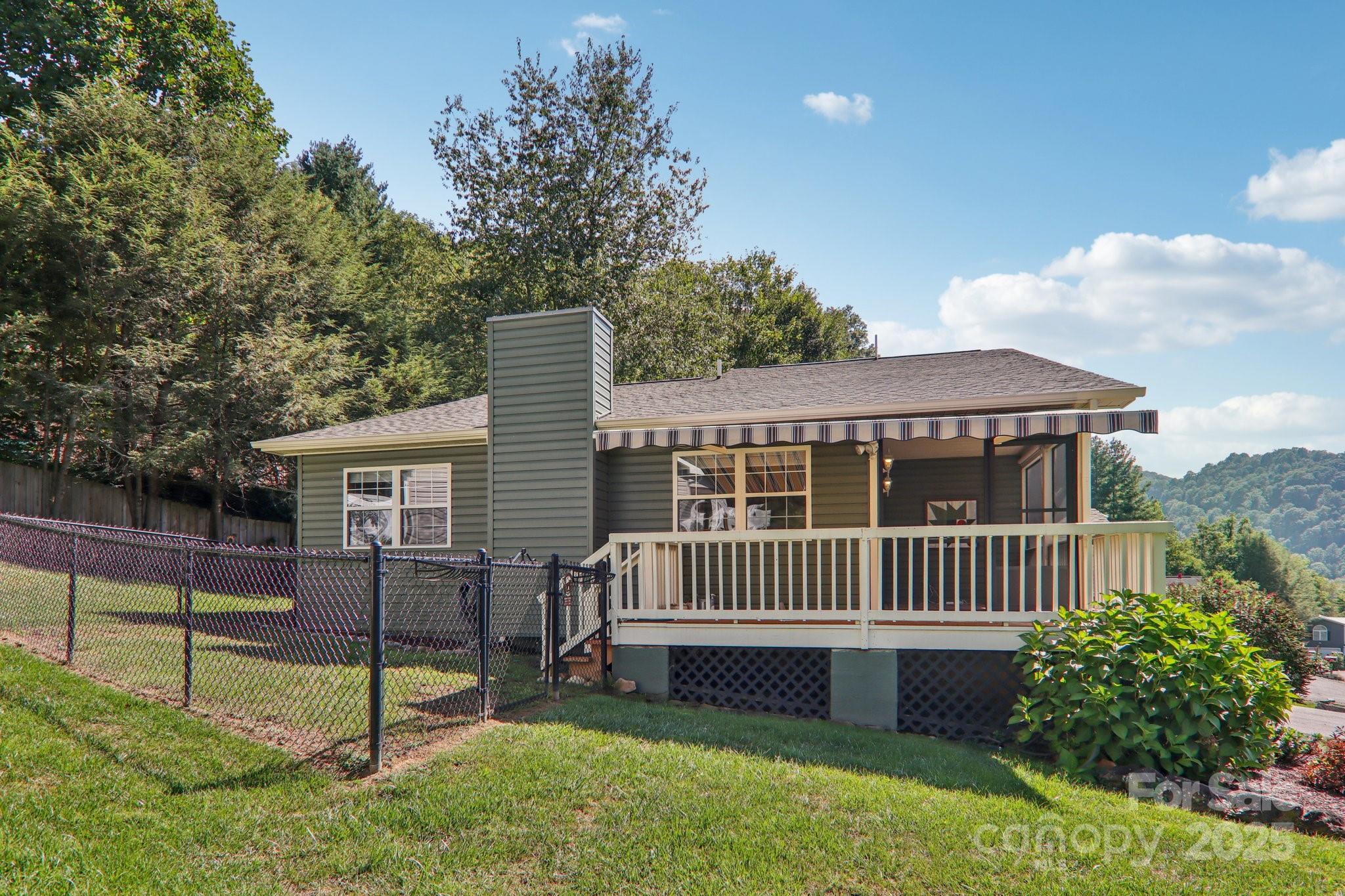 126 Pasco Loop Waynesville, NC 28785 - Photo 5 of 44 a view of a house with a yard and a garden