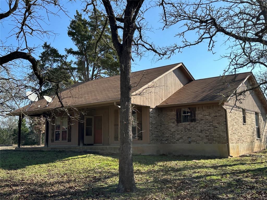 1047 Pr 3022 Elgin Elgin, TX 78621 - Photo 2 of 21 The home rests in a generous half-acre clearing, creating a peaceful setting surrounded by nature in every direction.