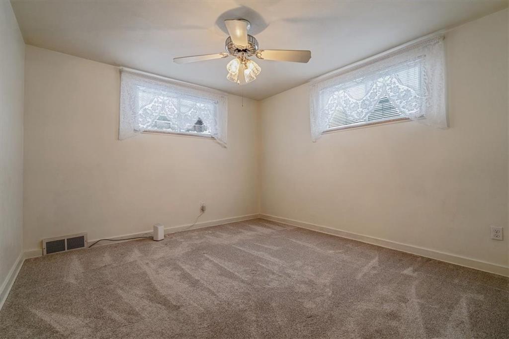 910 Foster Road Clairton, PA 15025 - Photo 22 of 50 an empty room with windows and fan