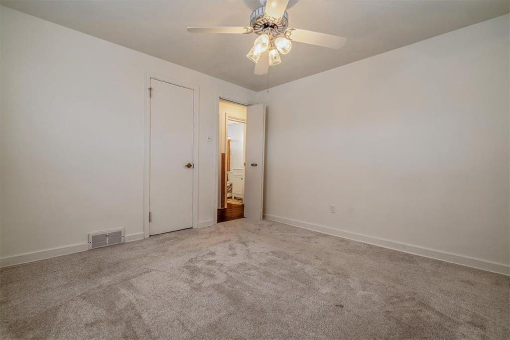 910 Foster Road Clairton, PA 15025 - Photo 24 of 50 an empty room with a ceiling fan and a fan