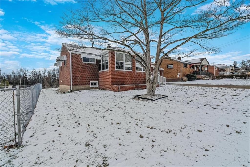 910 Foster Road Clairton, PA 15025 - Photo 42 of 50 a view of a house with a snow in the yard