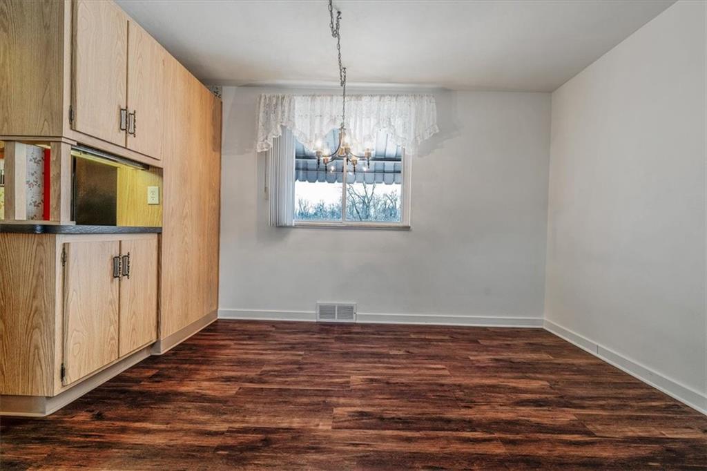 910 Foster Road Clairton, PA 15025 - Photo 10 of 50 a view of a kitchen with wooden floor and chandelier