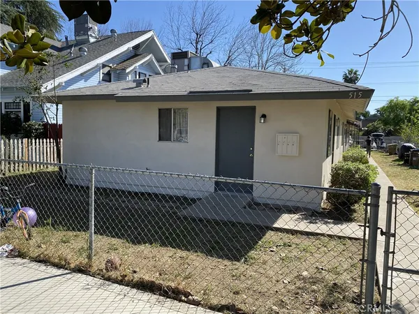 a view of a white house with large windows