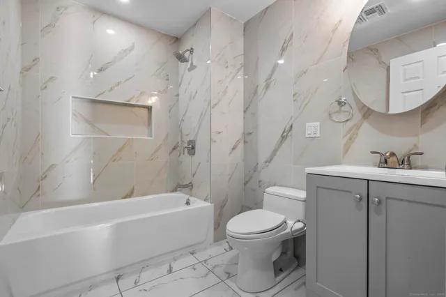 a bathroom with a toilet sink and bathtub