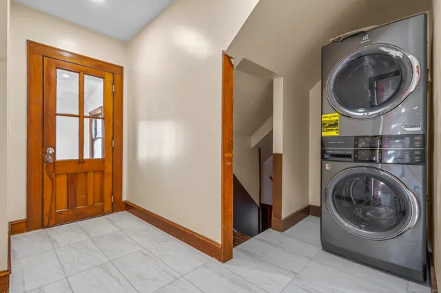 a view of a bedroom with washer and dryer