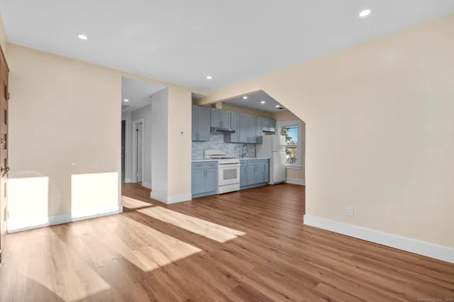 a view of a kitchen with a sink and a stove top oven