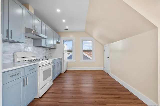 a kitchen with granite countertop a stove and a sink