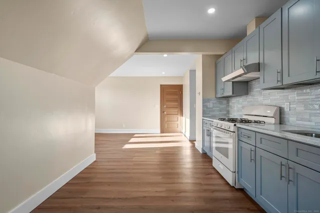 a kitchen with stainless steel appliances granite countertop a stove and a refrigerator