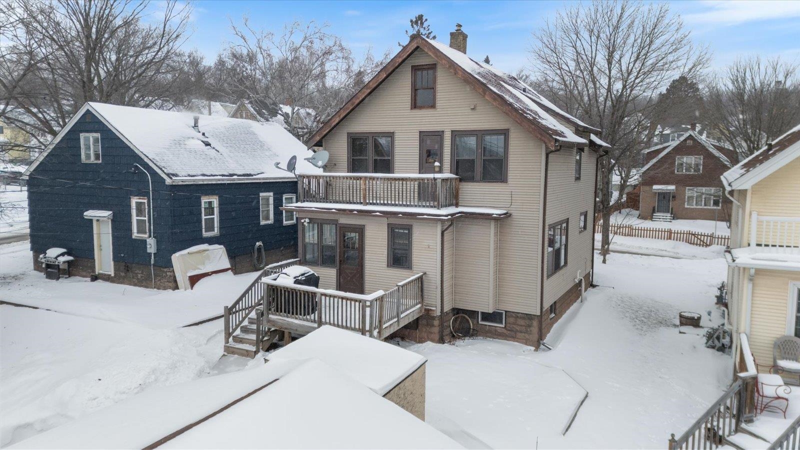 3070 Restormel Street Duluth, MN 55806 - Photo 33 of 48 Snow covered rear of property with a chimney and a wooden deck
