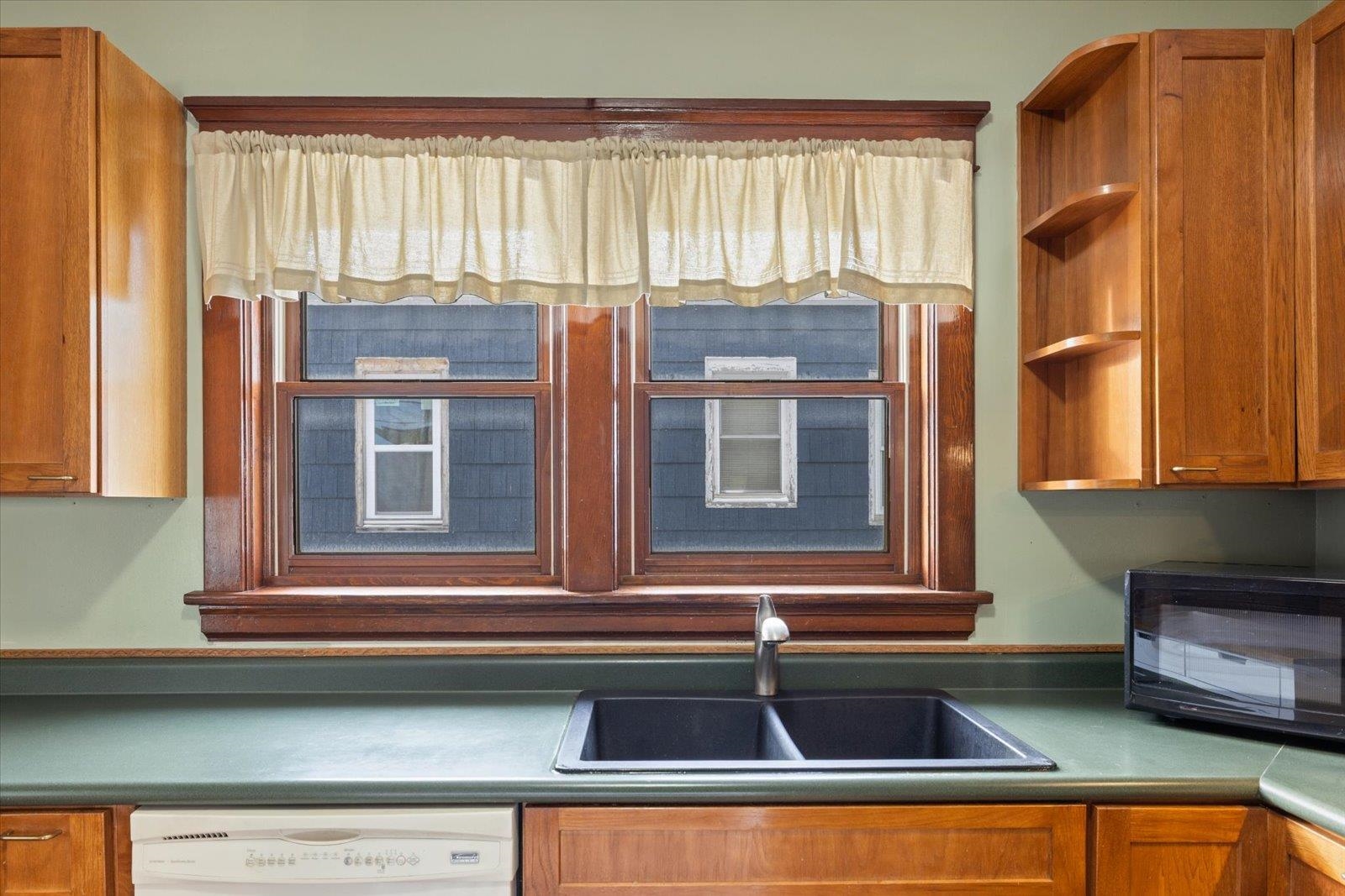 3070 Restormel Street Duluth, MN 55806 - Photo 9 of 48 Kitchen featuring wood finish cabinets, open shelves, dishwasher, black microwave, and dark countertops