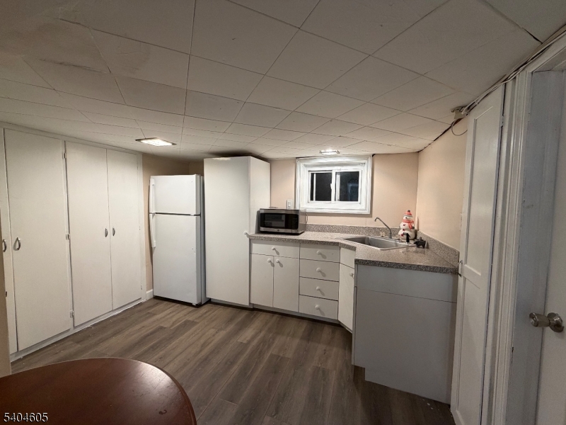 1090 Salem Road Union, NJ 07083 - Photo 23 of 44 a kitchen with a refrigerator sink and white cabinets
