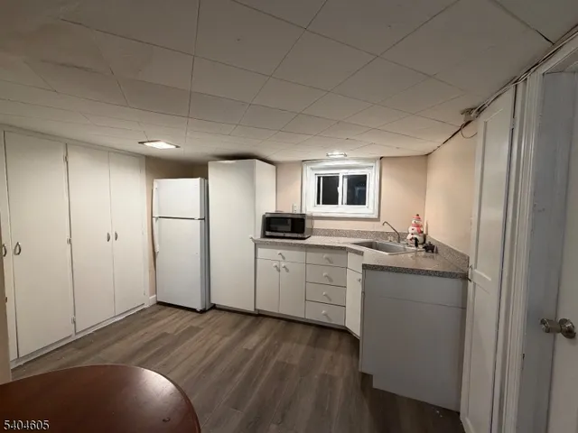 a kitchen with kitchen island a sink stove and cabinets