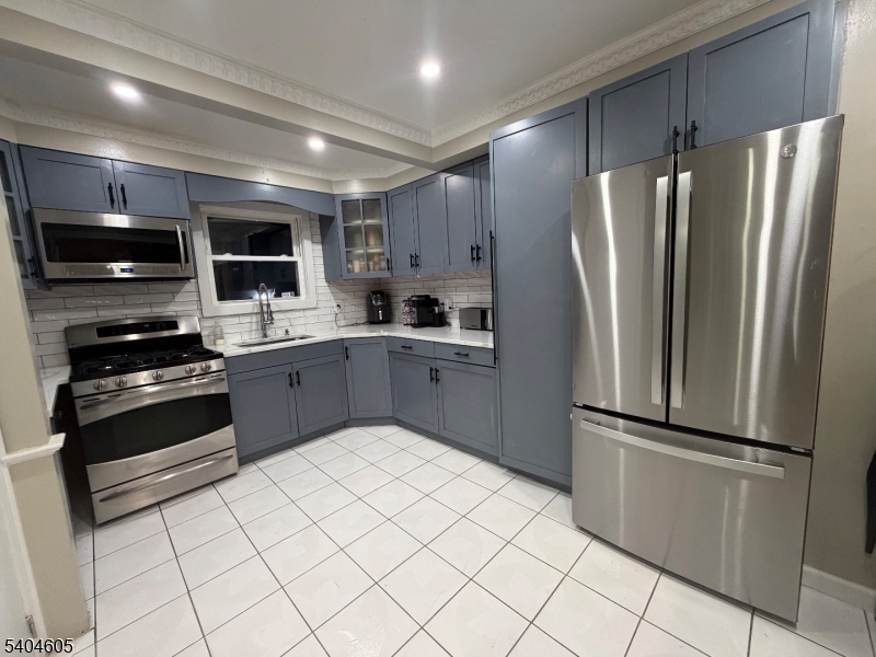 1090 Salem Road Union, NJ 07083 - Photo 4 of 45 a kitchen with stainless steel appliances a refrigerator sink and microwave