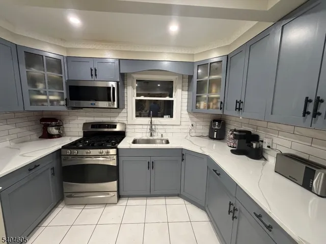 a kitchen with a sink stove and microwave