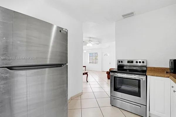 a kitchen with a sink cabinets and window