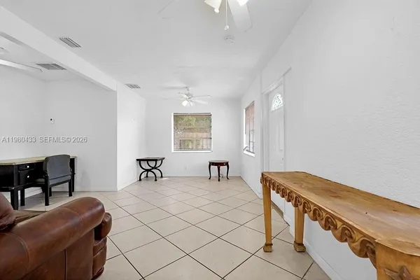 a living room with furniture and a dining table