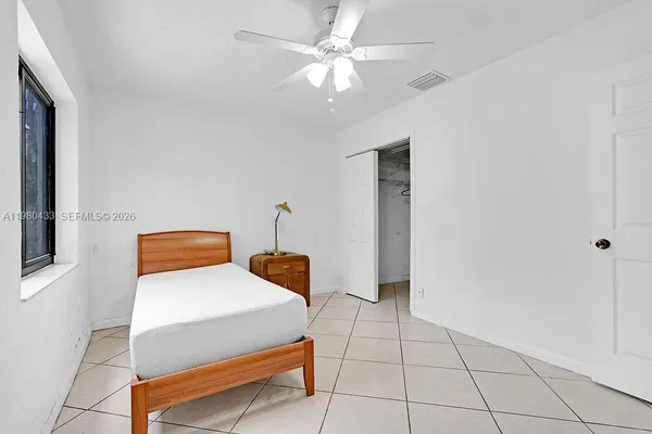 a bedroom with a bed and a television