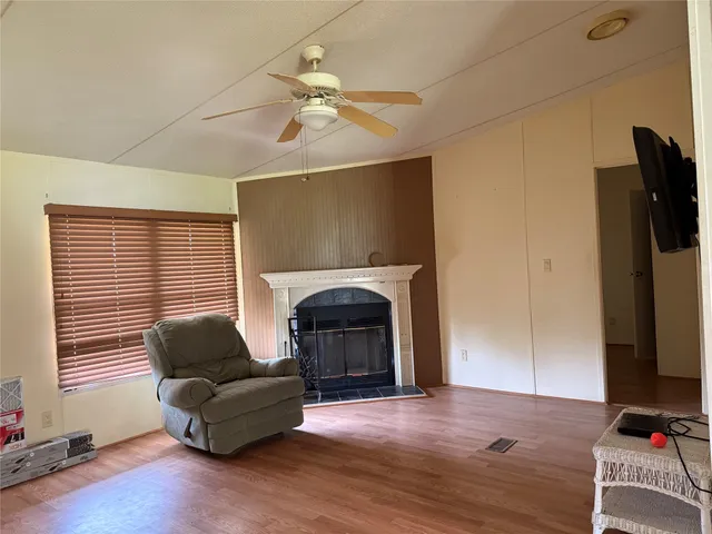an empty room with wooden floor and a window