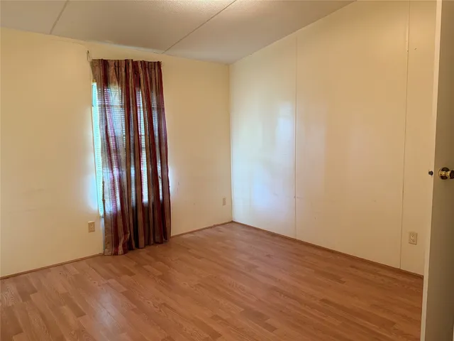 a view of a room with furniture and wooden floor