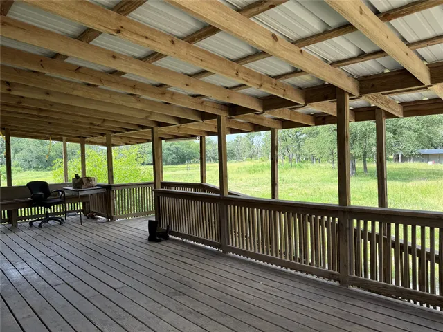 a livingroom with workspace chair and a window