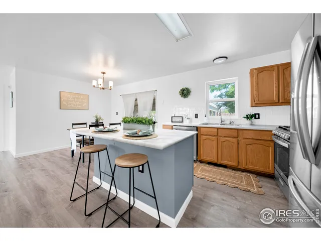 a kitchen with stainless steel appliances a refrigerator and microwave