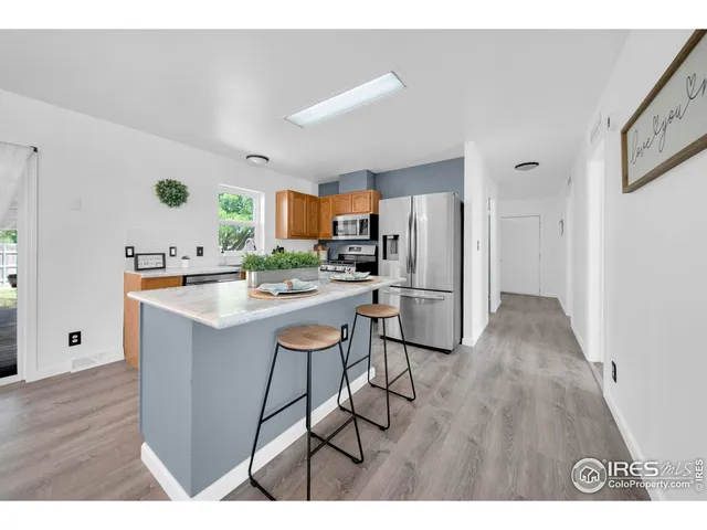 a living room with furniture and kitchen view