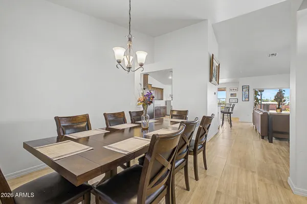 a view of a a dining room with furniture window and wooden floor
